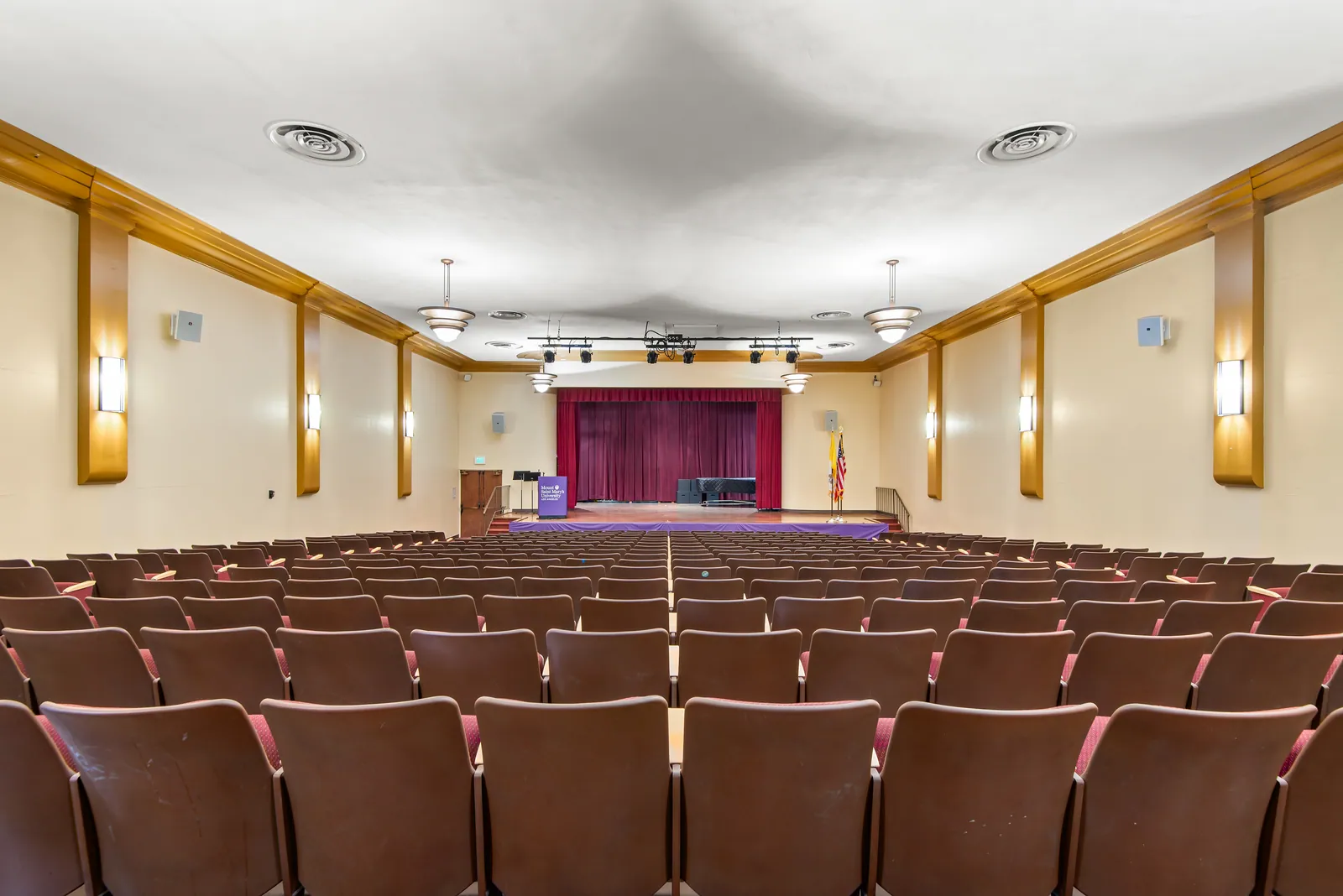 Red theater seating inside Hannon Theater at Chalon Campus