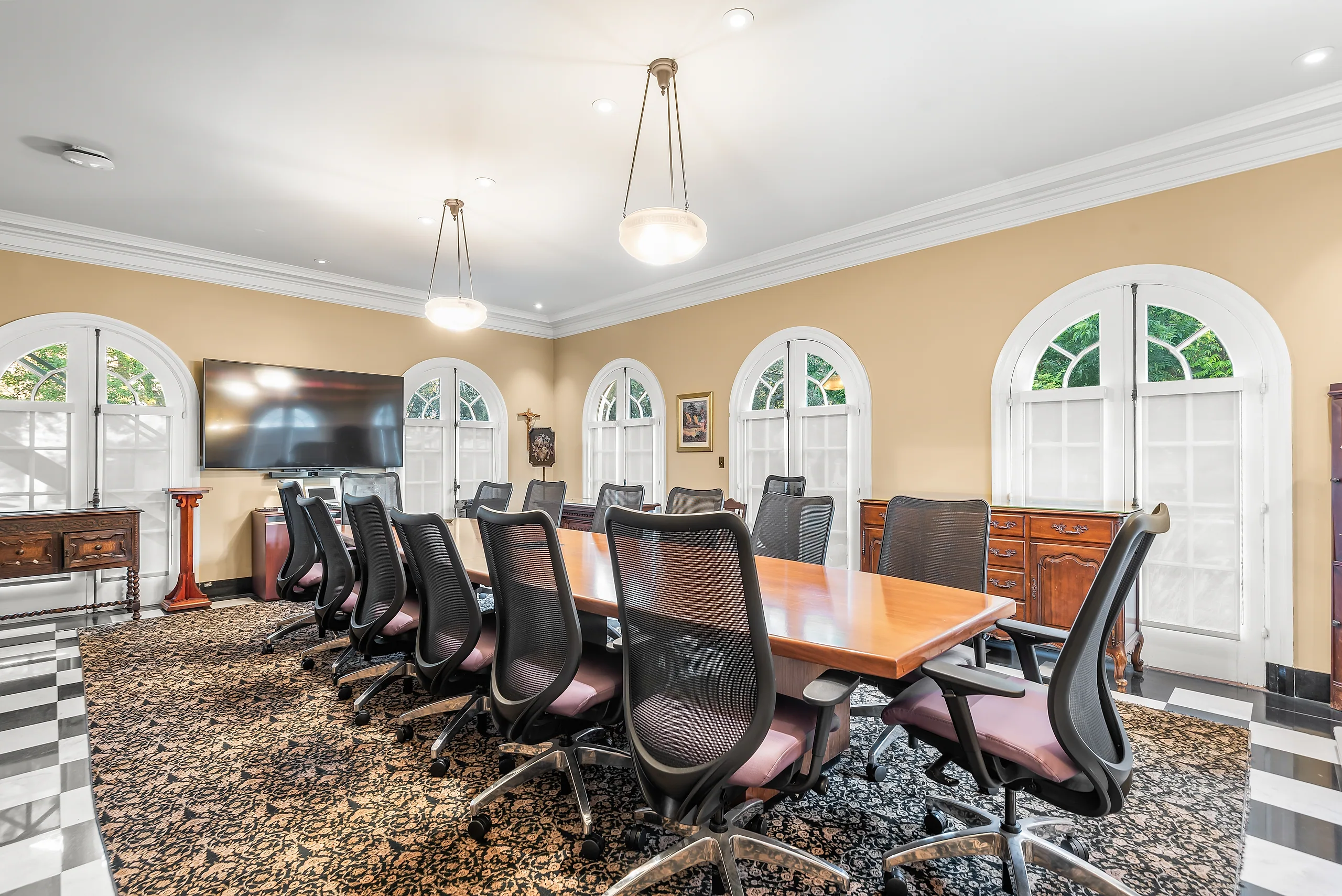Conference table beneath arched windows inside Building 10 at Doheny Campus