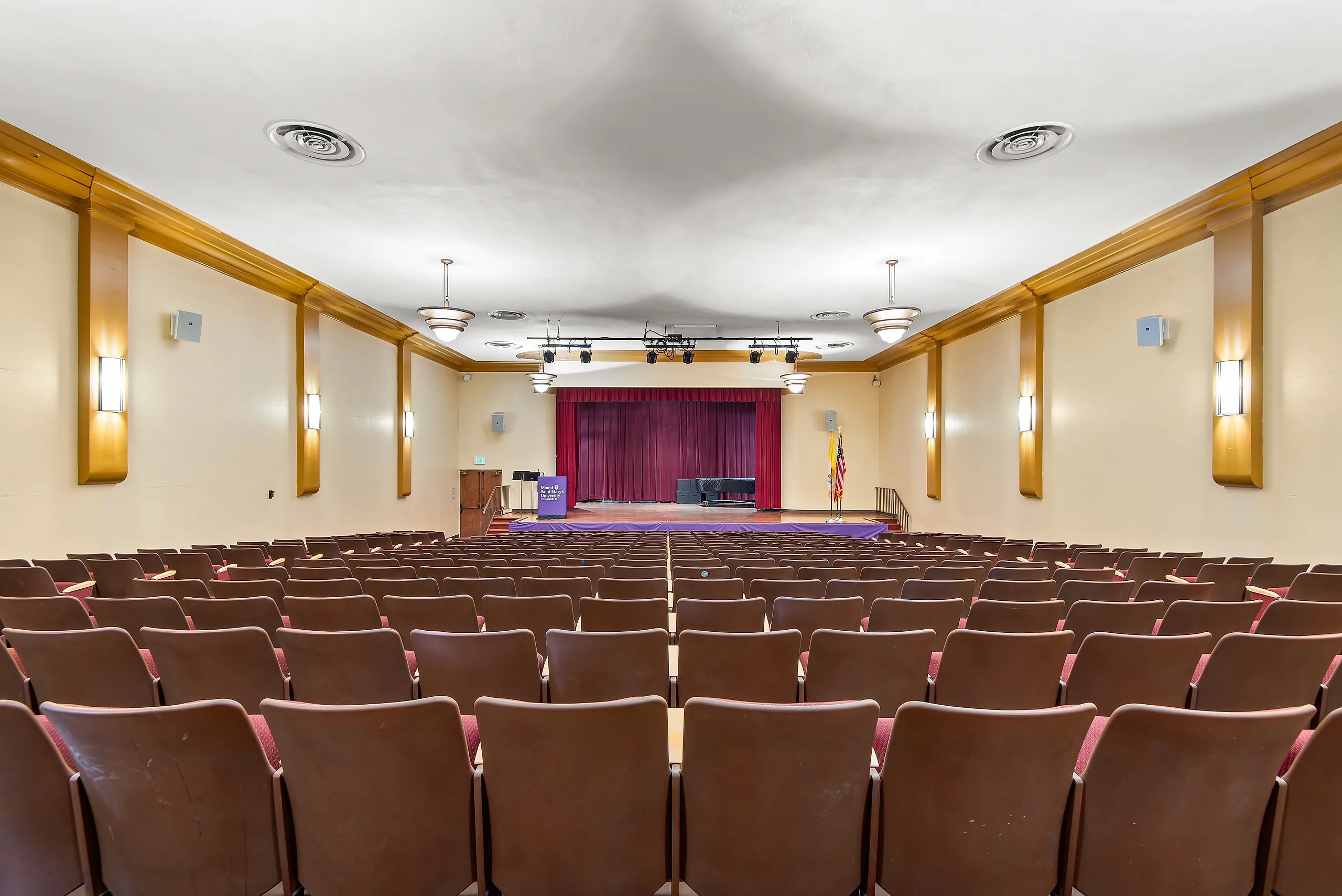Red theater seating inside Hannon Theater at Chalon Campus
