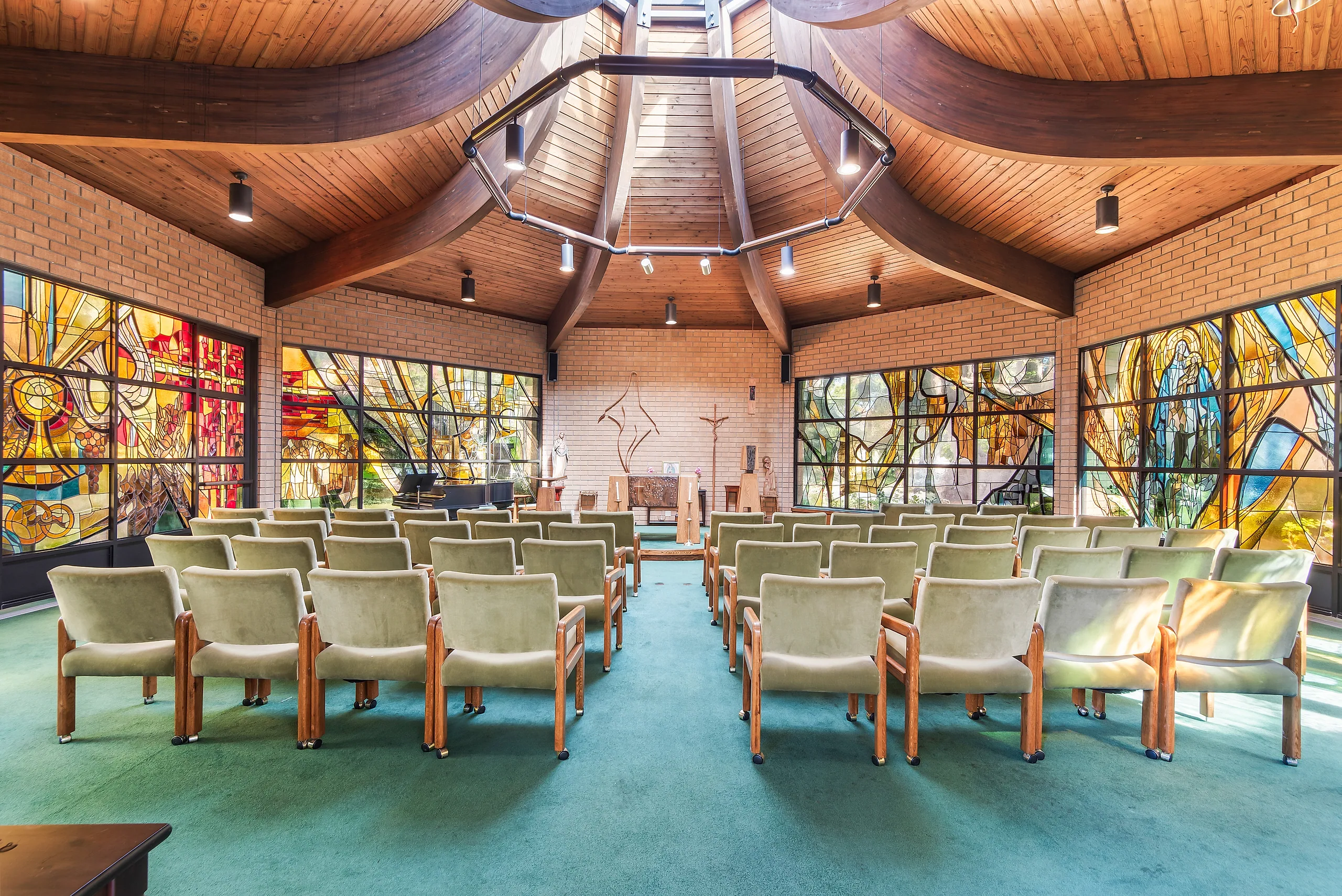 Stained glass and wooden ceiling inside Our Lady of Mercy Chapel at Doheny Campus