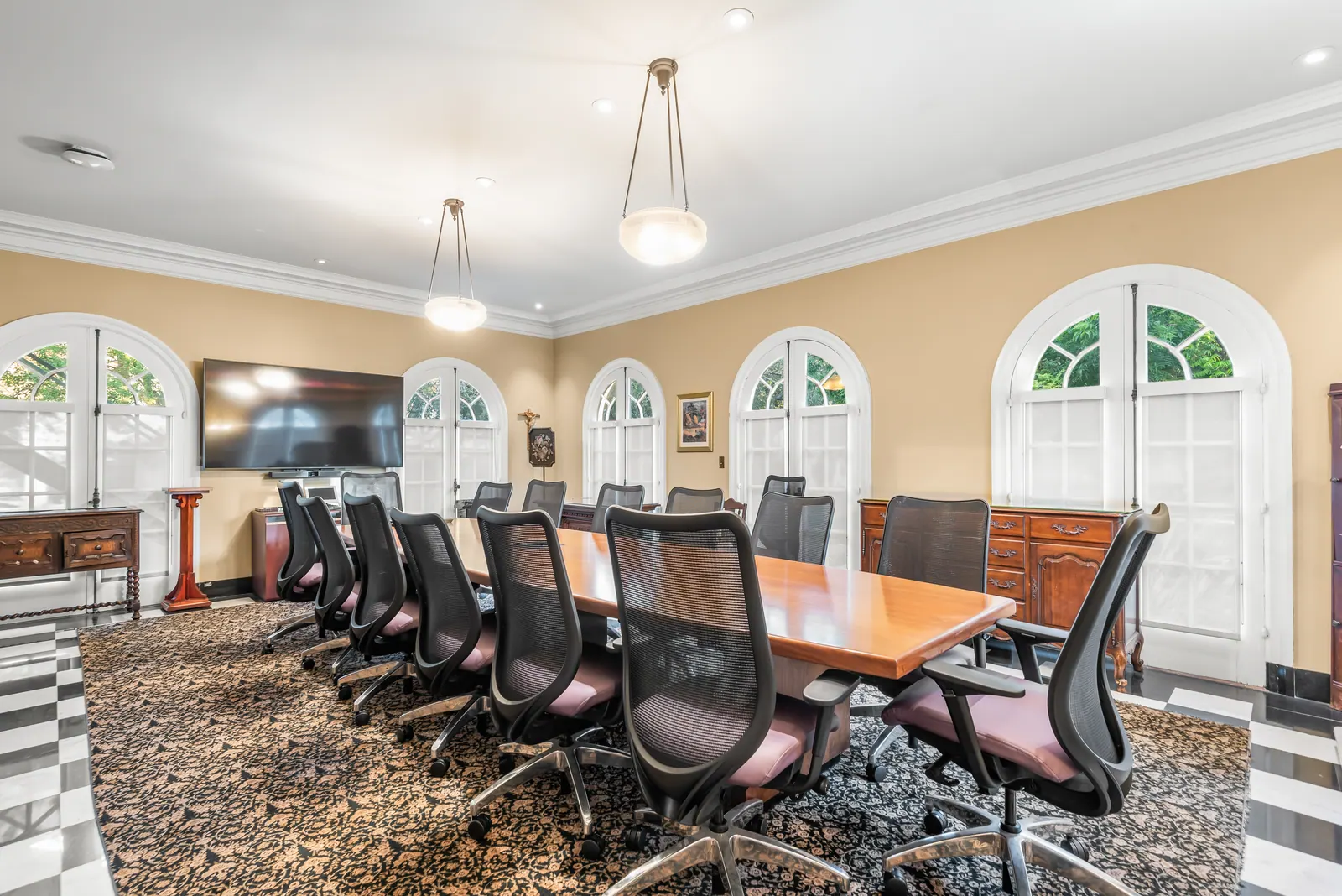 Conference table beneath arched windows inside Building 10 at Doheny Campus