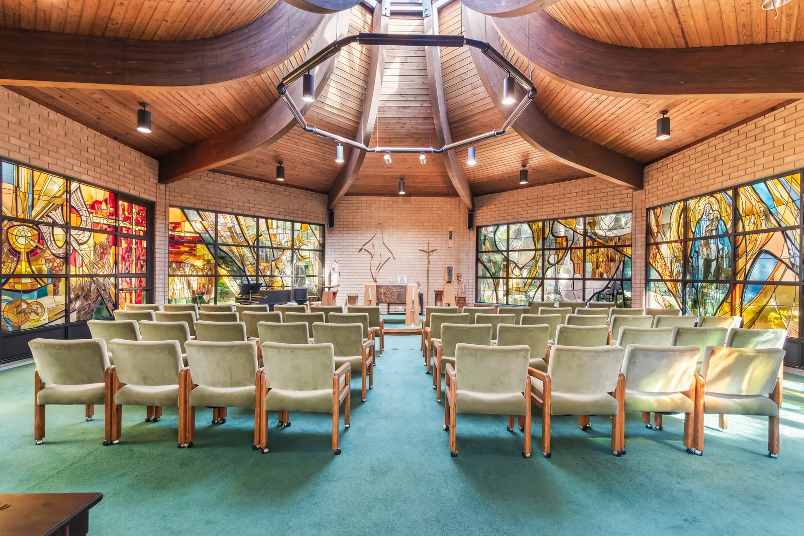 Stained glass and wooden ceiling inside Our Lady of Mercy Chapel at Doheny Campus